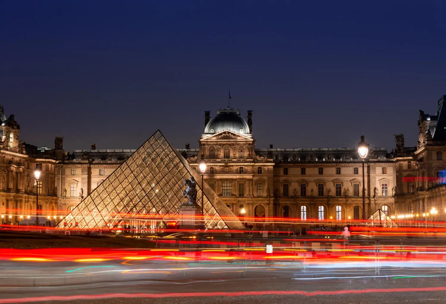 The Louvre and its pyramid lit at night